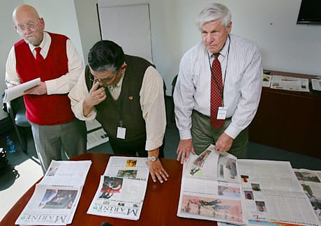 Print category judges for the Merit Awards Program, Mike Rhea, Ron Keene and Dick Truitt examine submissions at the Newseum, Washington D.C. on March 5, 2009. Photo by Sgt. Michael S. Cifuentes.